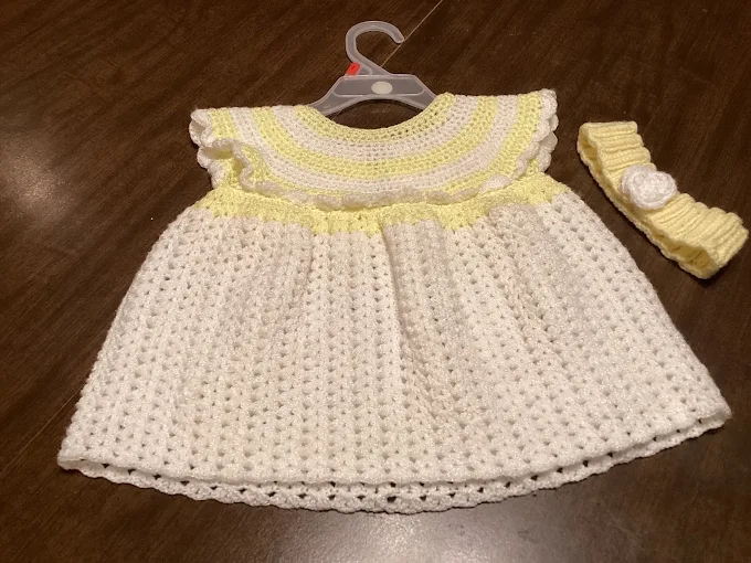 White crochet doll dress with yellow trimmed yoke and matching yellow headband